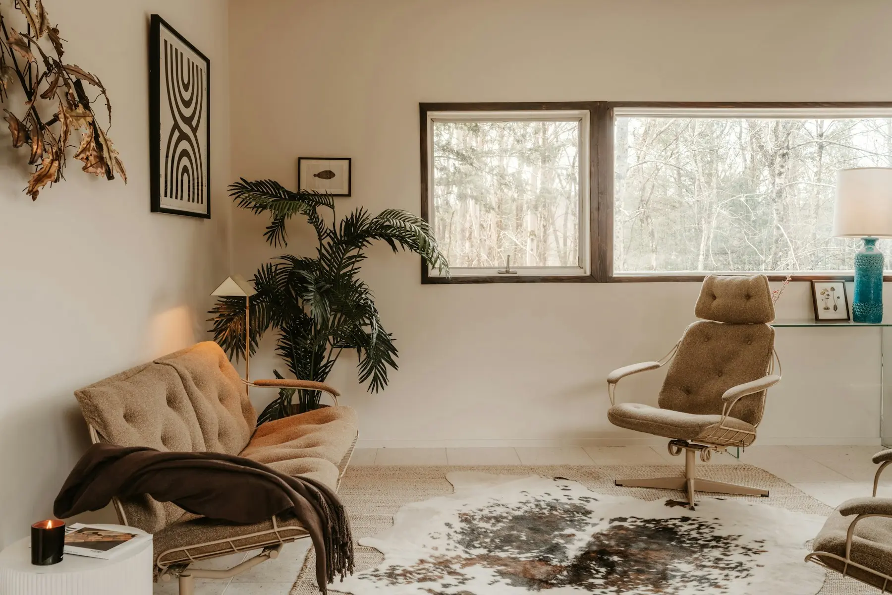 The living area at Lachica Homes with an armchair, potted plants and framed prints