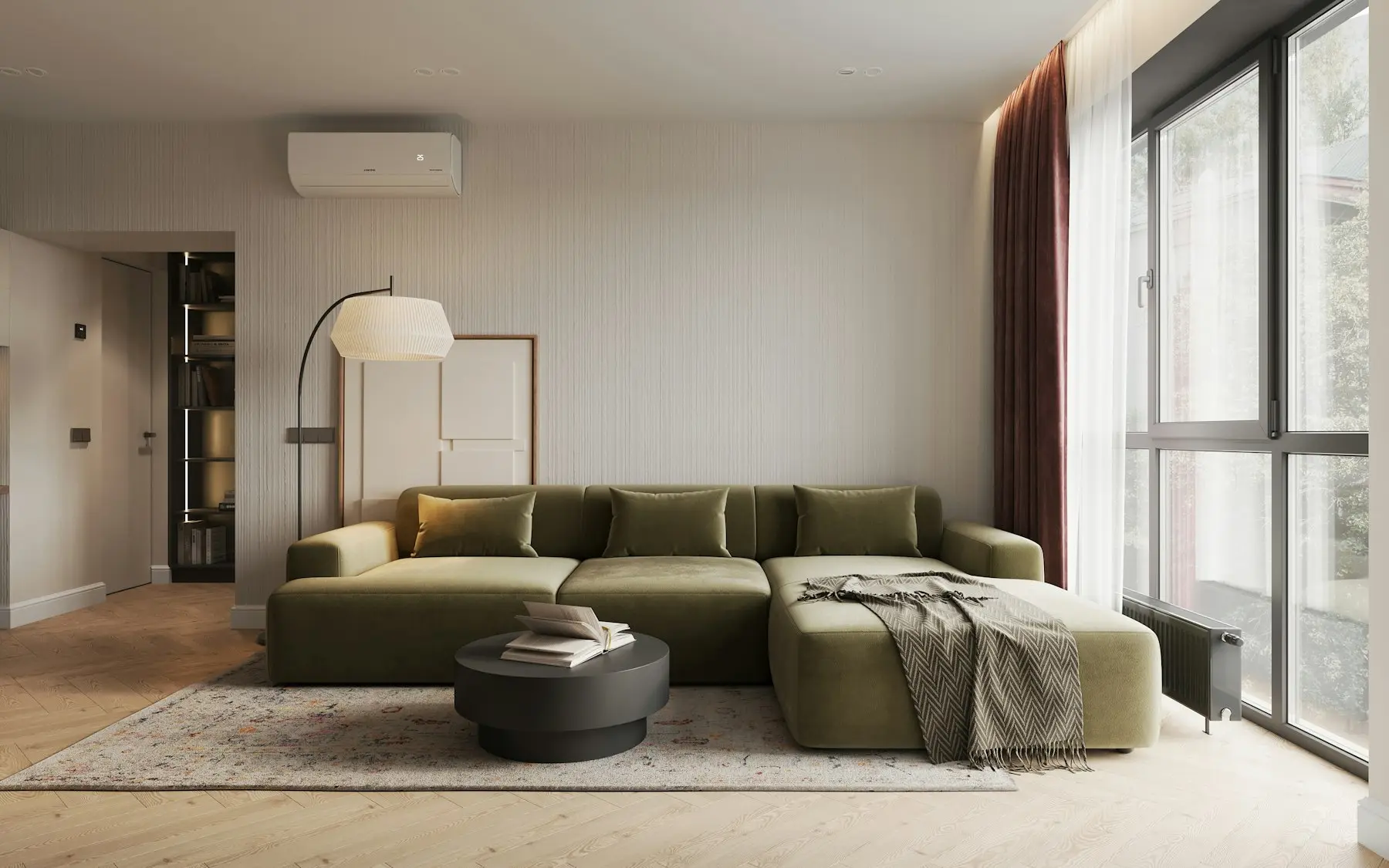 The sitting room seen from the balcony door, with a long low sofa and a window along one wall